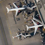 Aerial view of an airport apron with aircraft at stands