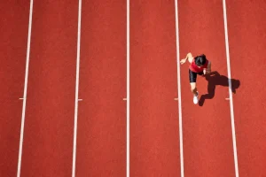 A running track from above, one athlete, every other lane empty