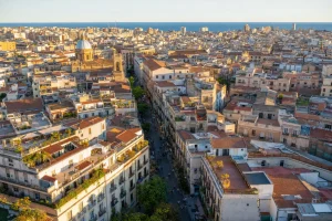 Aerial view of a dense Mediterranean city block grid at golden hour