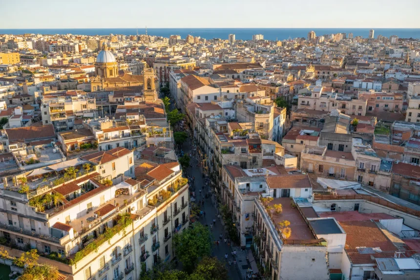 Aerial view of a dense Mediterranean city block grid at golden hour