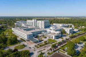 Aerial view of a large modern hospital complex among parkland