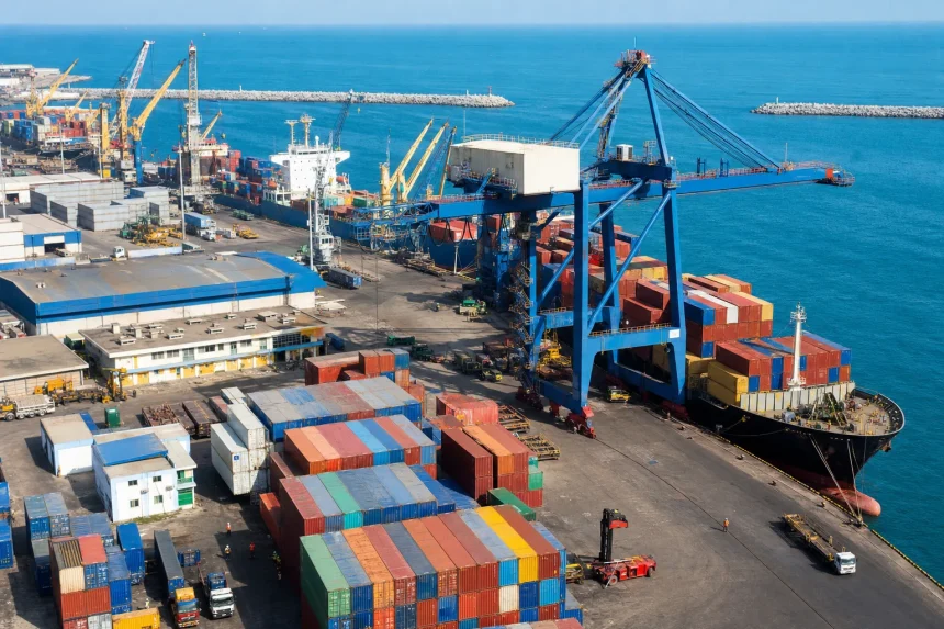 A working container port at midday with a gantry crane loading