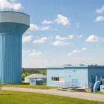 A municipal water tower and pumping station in bright afternoon light